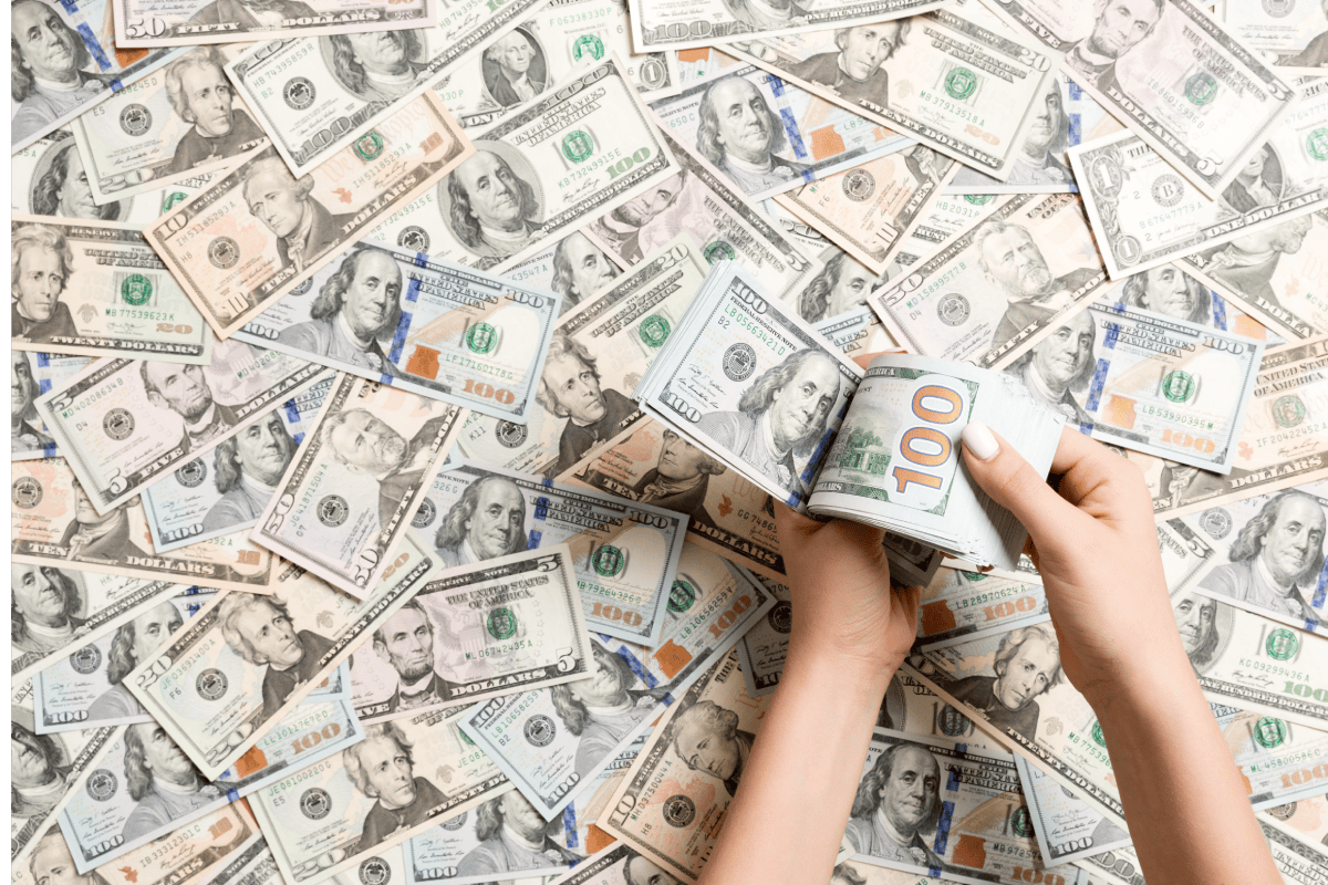 top-view-of-female-hands-counting-money-on-dollar-